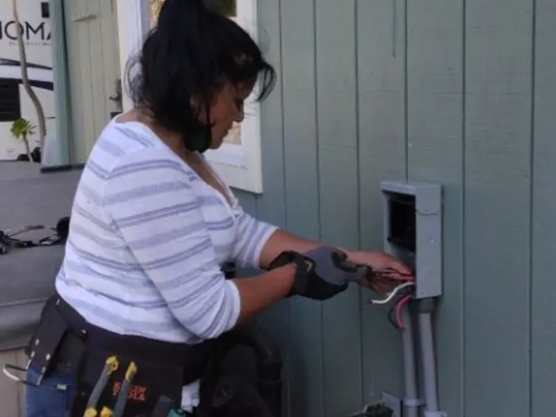 Licensed electrician wiring an exterior subpanel in Atkinson